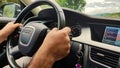 Car driving, hands on steering wheel