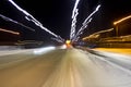 The car is driving at high speed on the night street of the city, blurred image along the lines of the road with zoom Royalty Free Stock Photo