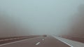 Car driving on highway entering fog Royalty Free Stock Photo