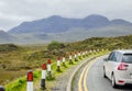 Car driving on the left hand side of the road in rural area of Scotland, UK, Europe. Royalty Free Stock Photo