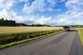 Car driving on a narrow straight road Royalty Free Stock Photo