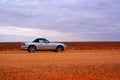 Car driving over desert