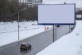 Car driving past an advertising stand on the winter highway in Moscow