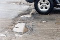 Car driving through a pothole with splashes of water Royalty Free Stock Photo