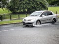 Car driving through puddle. Heavy rain. Auckland, New Zealand - January 27, 2023