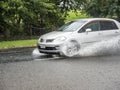 Car driving through puddle. Heavy rain. Auckland, New Zealand - January 27, 2023