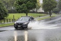 Car driving through puddle. Heavy rain. Auckland, New Zealand - January 27, 2023