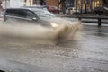 The car is driving in a puddle. Sprays from under the wheels Royalty Free Stock Photo