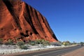 Car driving on a road along Uluru Ayers Rock in Uluru-Kata Tjuta National ParkNorthern Territory Australia Royalty Free Stock Photo