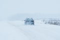 The car is driving on a road in a blizzard Royalty Free Stock Photo