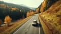 Car driving on the road in the forest in autumn season. Nature adventure in colorful fall forest. Autumn colors bring forest to