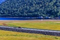 Car driving on a road by lake Tinn, Norway