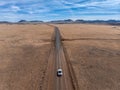 Car driving on sand desert scenic empty road at summer day. Travel concept Royalty Free Stock Photo