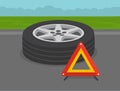 Car driving tips. Perspective close-up summer tire and warning triangle. Royalty Free Stock Photo