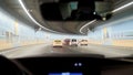 Car driving through tunnel, highway tunnel at night. Interior of an urban tunnel with car,motion blur. Cars leaving