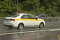 The car is driving on a wet road. Slippery road after rain. Splashes from under the wheels of transport. Rain on the highway Royalty Free Stock Photo