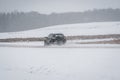 The car is driving on a winter road in a blizzard Royalty Free Stock Photo