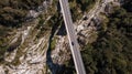 Car Droving Over Dangerous Bridge at Valley. Aerial Top Down Drone View Royalty Free Stock Photo