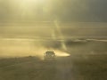 Car on dust road at Death Valley