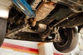 Car emission catalytic converter being inspected at the car garage Royalty Free Stock Photo