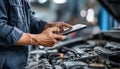 The car engine being diagnosed with a digital tablet by a mechanic Royalty Free Stock Photo