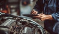 The car engine being diagnosed with a digital tablet by a mechanic Royalty Free Stock Photo