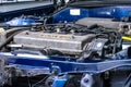 Car engine repaired under the hood opened on blue car on the auto service garage Royalty Free Stock Photo