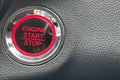 car engine start stop button on dark leather background. copy space Royalty Free Stock Photo