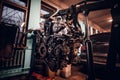 Car engine suspended on a hydraulic hoist in the workshop Royalty Free Stock Photo