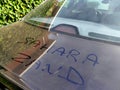 Car in Europe covered in Sahara sand transported by southerly winds, words written in dust Royalty Free Stock Photo