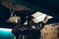 Car examination. Young woman, auto mechanic working at auto service station using different work tools. Gender equality Royalty Free Stock Photo