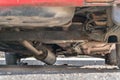 Car exhaust, muffler fallen down - view of chassis of a car Royalty Free Stock Photo