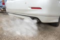 Car exhaust pipe comes out strongly of smoke, air pollution concept Royalty Free Stock Photo