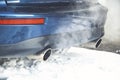 Car exhaust pipe, which comes out strongly exhaust gases.It is winter and the car is very dirty Royalty Free Stock Photo