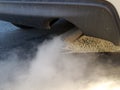 Car exhaust or smoke and black asphalt