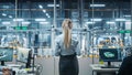 Car Factory Office: Successful Female Chief Engineer Overlooking Factory Production Conveyor