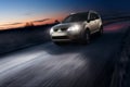 Car fast speed drive on asphalt road at dusk Royalty Free Stock Photo