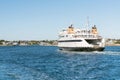 Car ferry going into a harbour on a clear autumn day