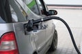 Car fill with gasoline at gas station. Close up of pumping gasoline fuel in gray car at gas station Royalty Free Stock Photo
