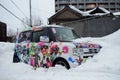 A car filled with cartoon Sticker is buried half by the snow, Otaru City, Hokkaido, Japan.