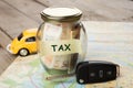 Car finance concept - money glass with word Tax, car key Royalty Free Stock Photo