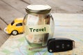 Car finance concept - money glass with word Travel, car key and Royalty Free Stock Photo