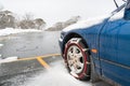 Car with fitted tire chains or snow chains on its front wheels Royalty Free Stock Photo