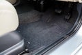 Car floor mats of black carpet with gas pedals and brakes in the workshop for the detailing vehicle after dry cleaning Royalty Free Stock Photo