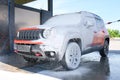 Car in foam. Car getting a wash with soap, car washing Royalty Free Stock Photo