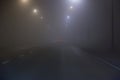 Car fog on road lit by lamps Royalty Free Stock Photo