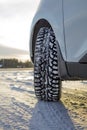 Car front corner, winter tire and the snowy landscape in Finland. Royalty Free Stock Photo