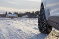 Car front corner, winter tire and the snowy landscape in Finland. Royalty Free Stock Photo