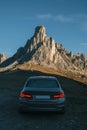 Car in front of the iconic view of Dolomite Alps in Italy. Focus on the mountain. Royalty Free Stock Photo