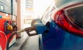 Car fueling at gas station. Refuel fill up with petrol gasoline. Petrol pump filling fuel nozzle in fuel tank of car at gas Royalty Free Stock Photo